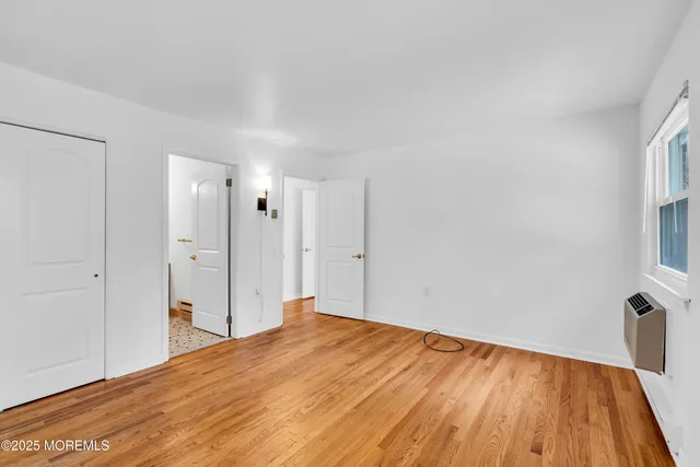 a view of a room with wooden floor and a sink