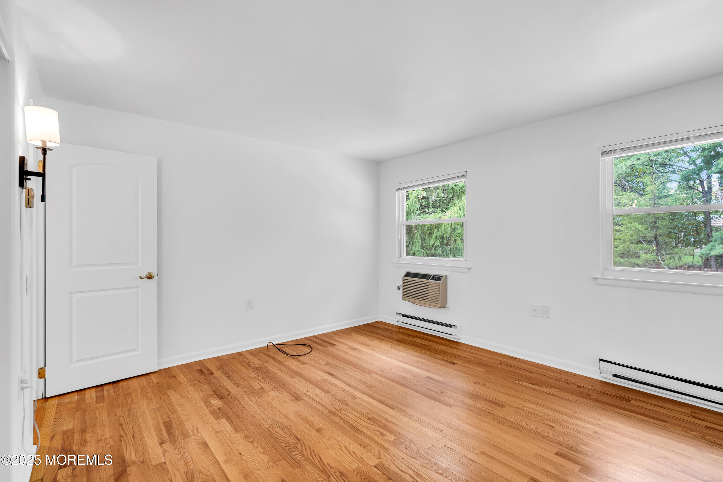 26 Columbus Boulevard, Unit A Whiting, NJ 08759 - Photo 14 of 23 a view of empty room with wooden floor and fan