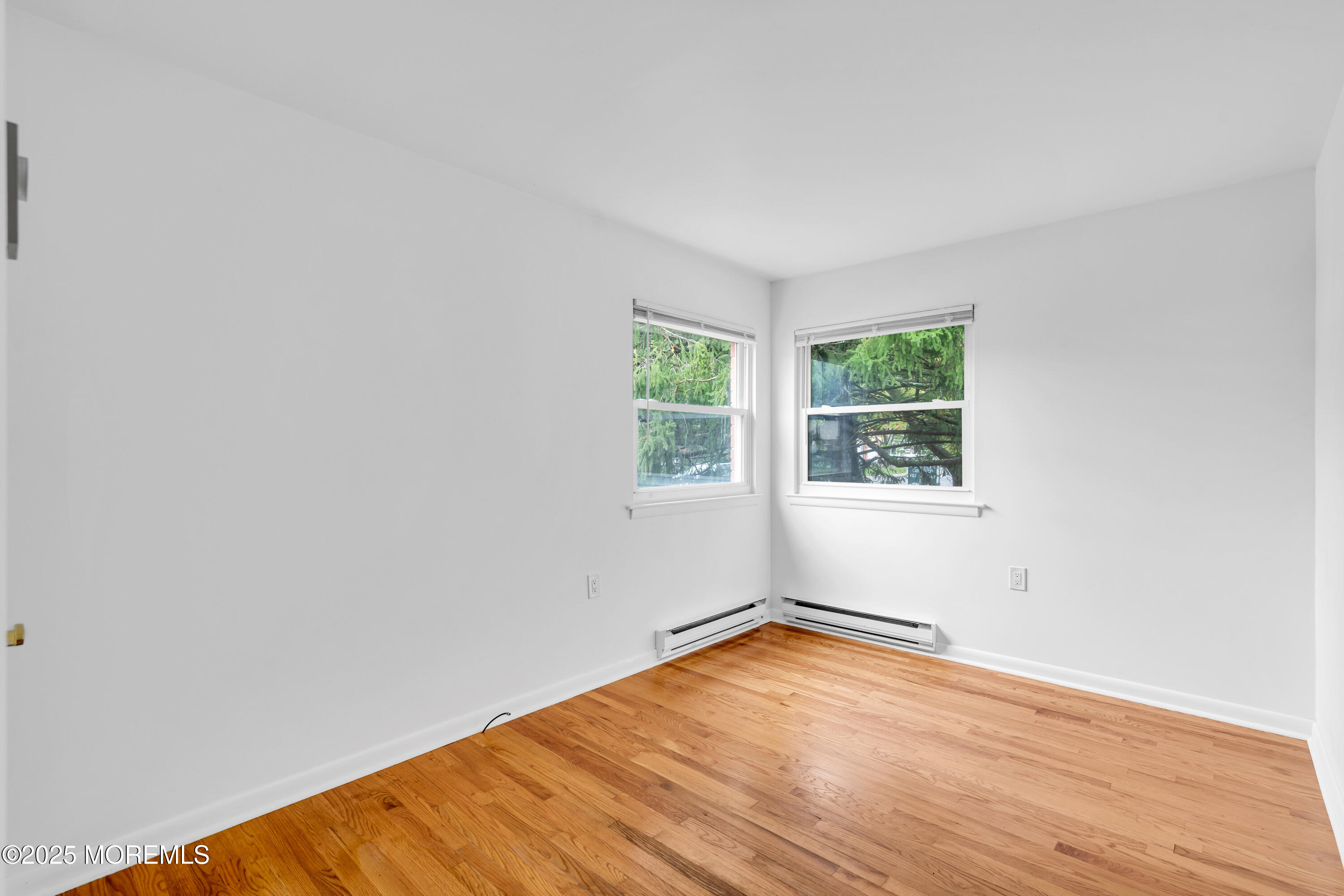 26 Columbus Boulevard, Unit A Whiting, NJ 08759 - Photo 17 of 23 an empty room with wooden floor and windows