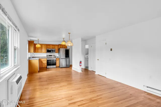 a big room with wooden floor and windows