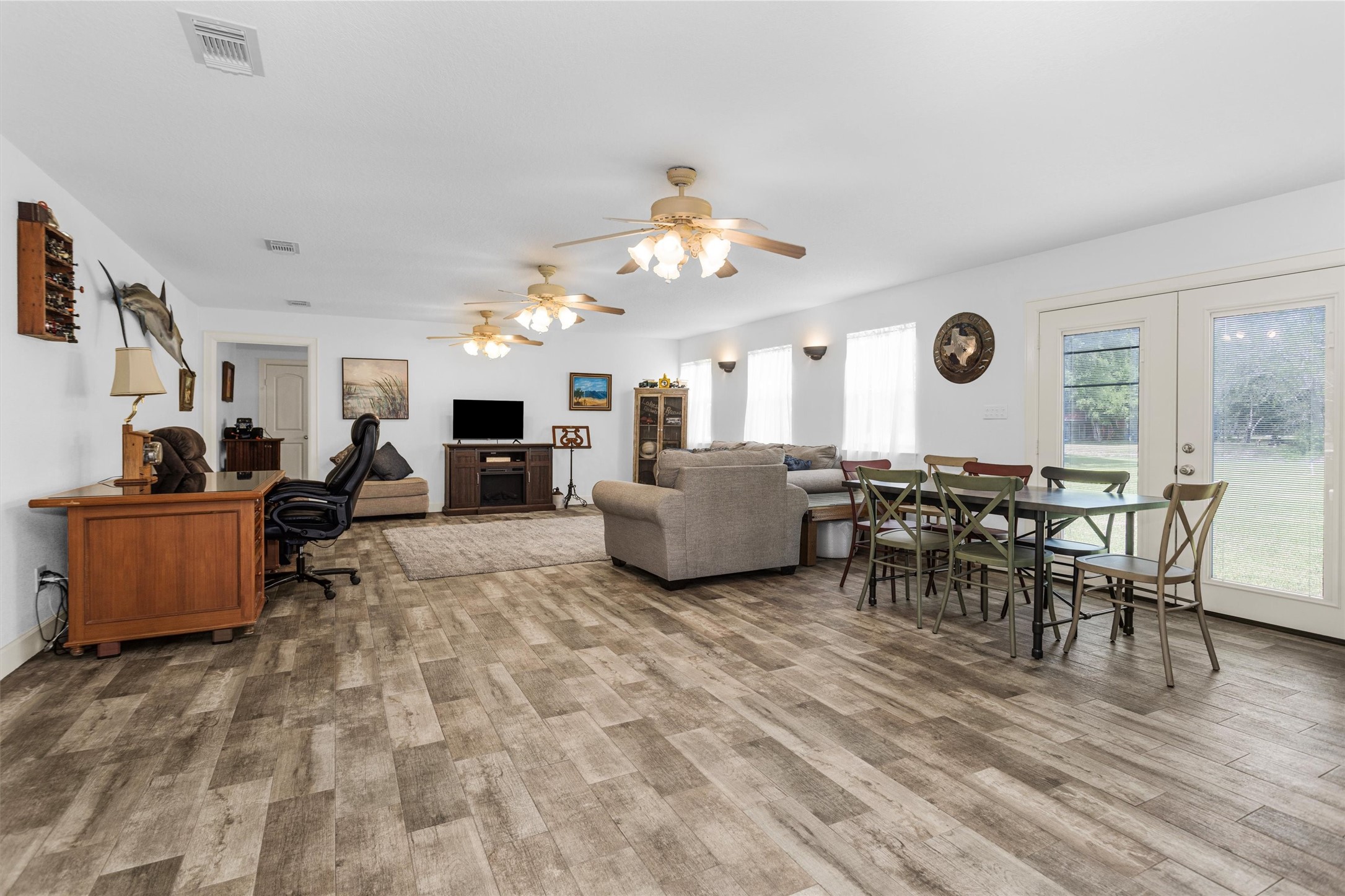 4402 Spears Road Manvel, TX 77578 - Photo 29 of 38 a living room with furniture a window and a flat screen tv