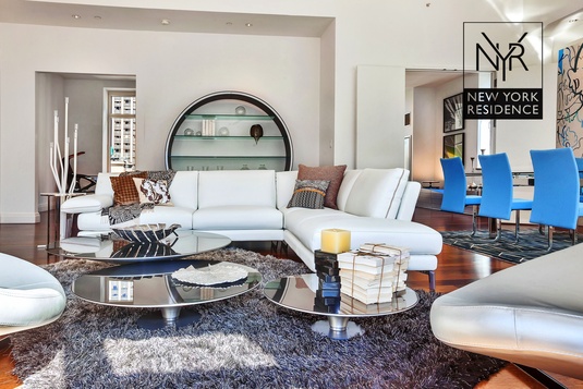 a living room with furniture and a mirror