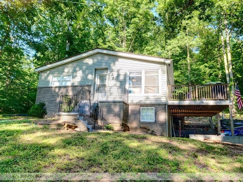485 Powder House Road Powell, TN 37849 - Photo 1 of 24 a front view of a house with a yard