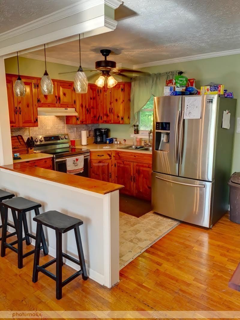 485 Powder House Road Powell, TN 37849 - Photo 3 of 24 a kitchen with stainless steel appliances a stove a refrigerator and a dining table