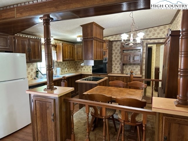 32 Stoneacres Lane Independence, VA 24348 - Photo 16 of 27 a kitchen with stainless steel appliances granite countertop a sink and a refrigerator