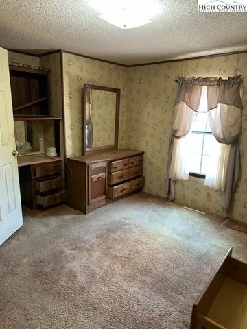a hallway with a wooden floor and furniture