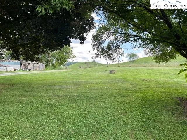 a view of a field with an trees