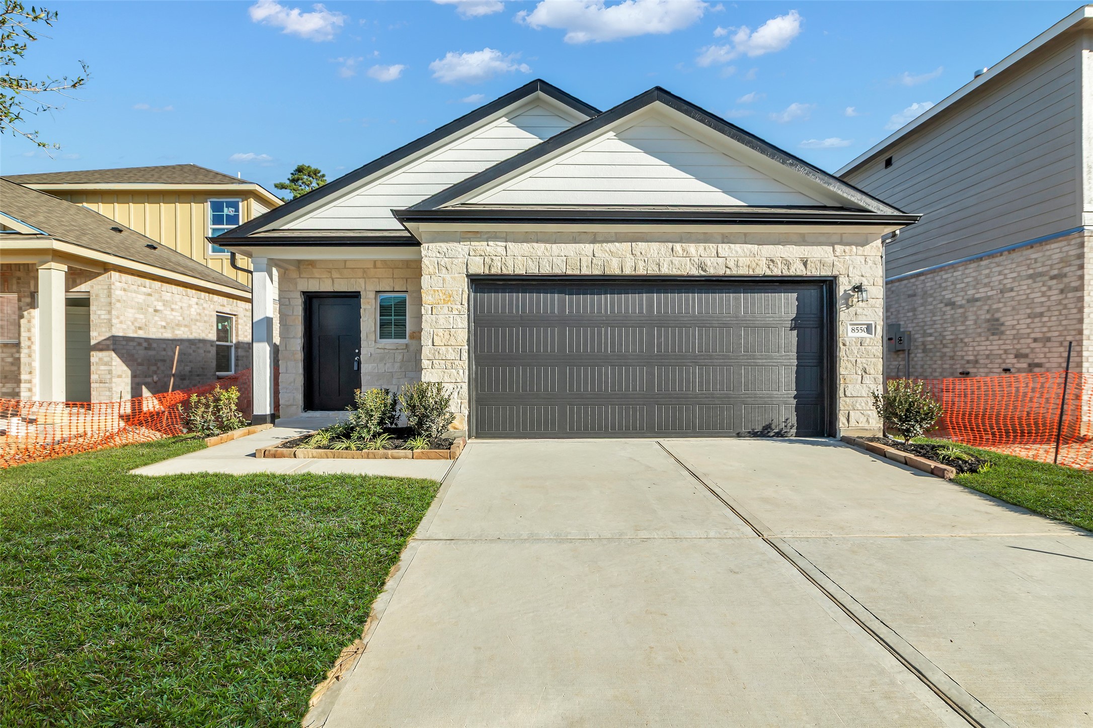 8550 Blueberry Ash Street Magnolia, TX 77354 - Photo 1 of 40 a front view of a house with a yard and garage