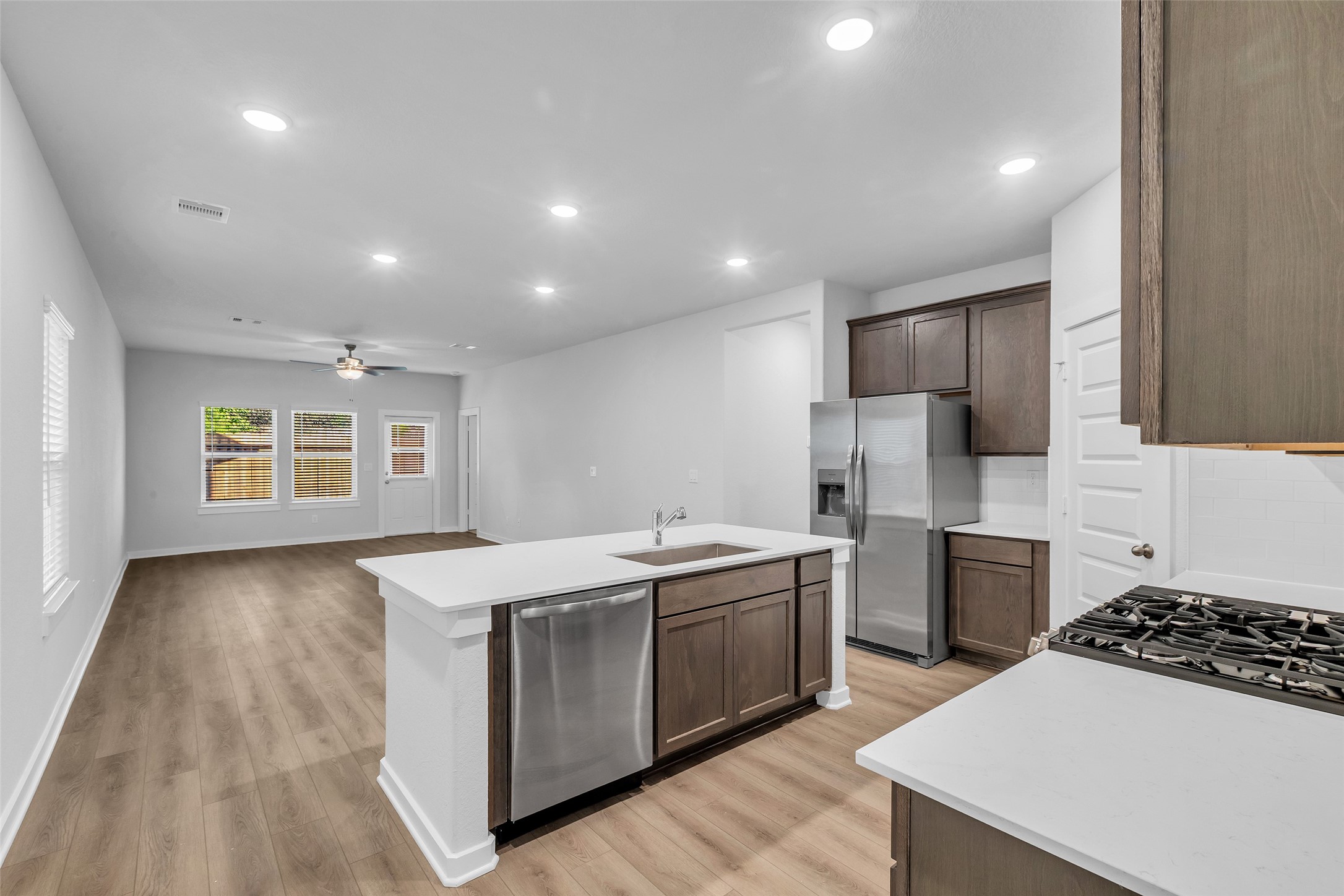 8550 Blueberry Ash Street Magnolia, TX 77354 - Photo 12 of 40 a kitchen that has a sink and a stove in it