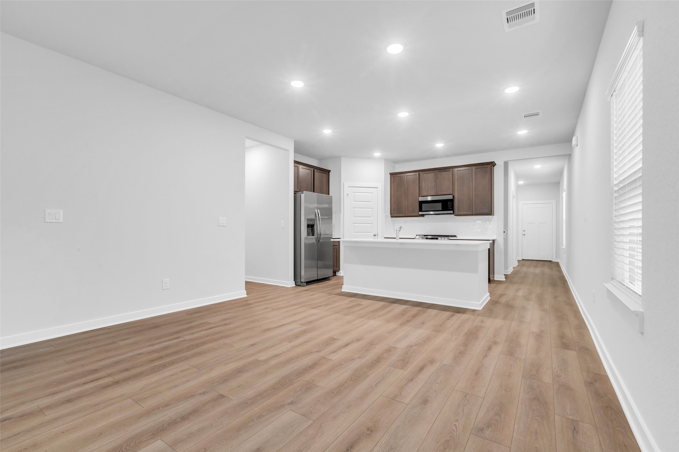 8550 Blueberry Ash Street Magnolia, TX 77354 - Photo 13 of 40 a view of a electric appliances in kitchen and empty room with wooden floor