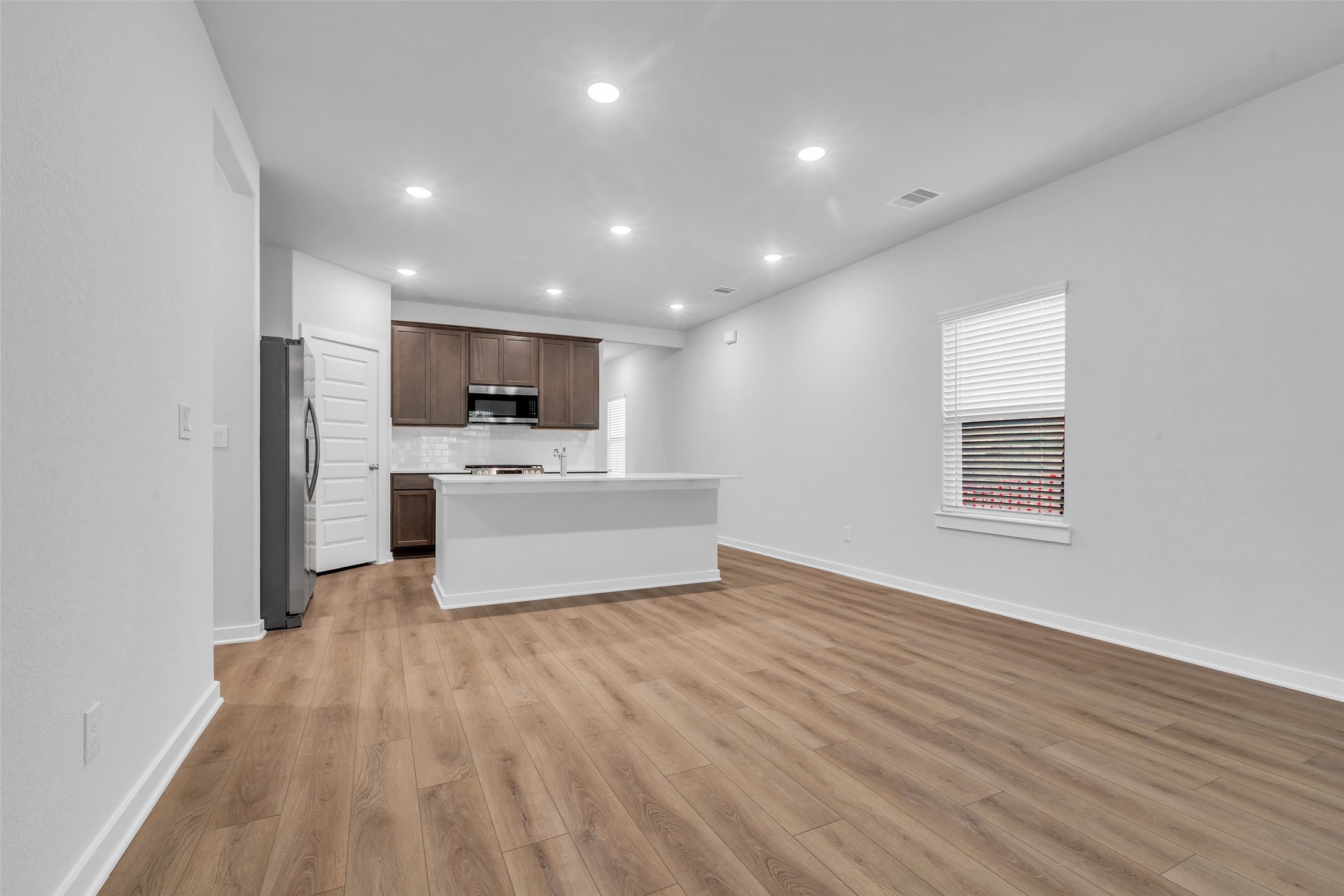8550 Blueberry Ash Street Magnolia, TX 77354 - Photo 15 of 40 a view of a electric appliances in kitchen and empty room with wooden floor