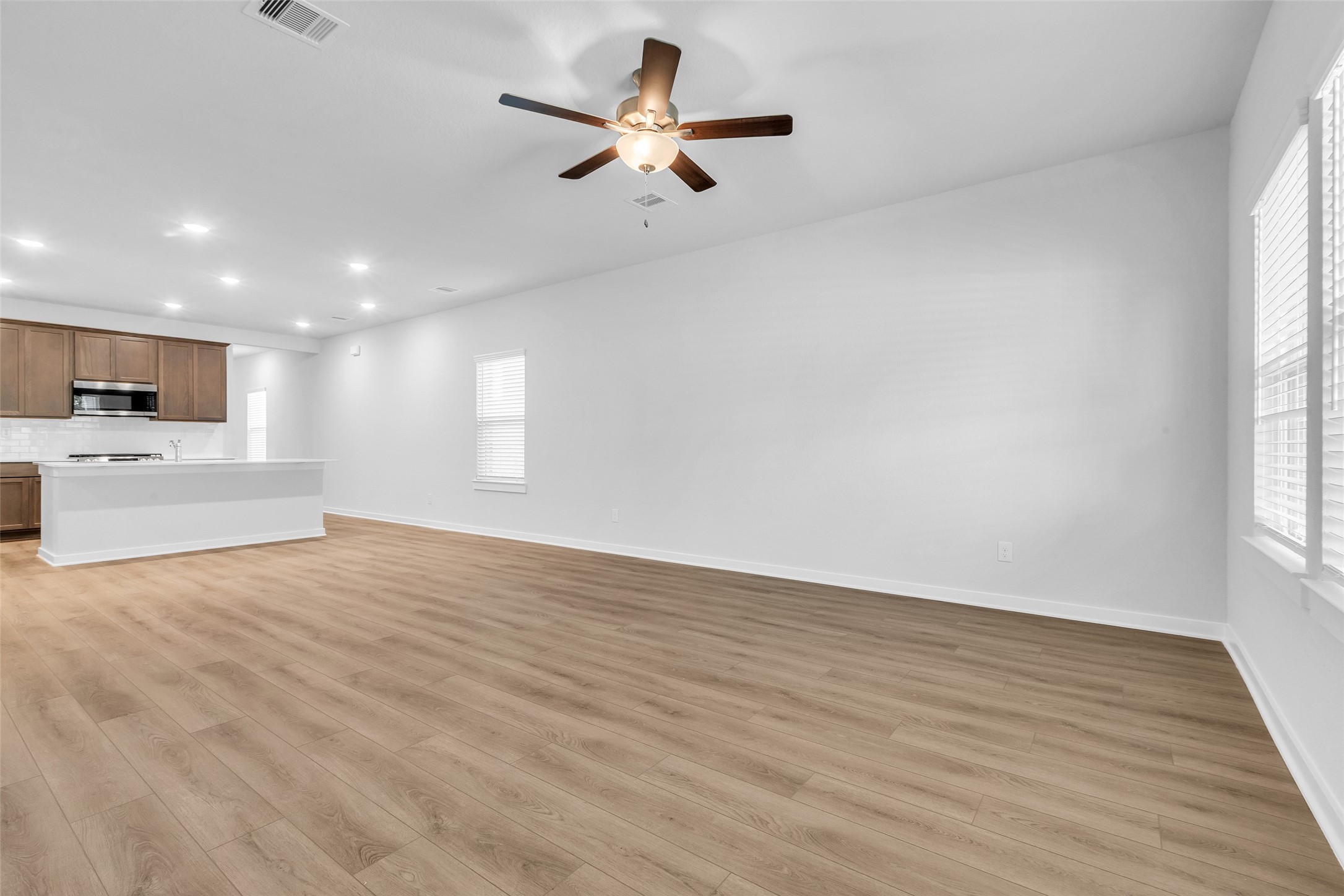 8550 Blueberry Ash Street Magnolia, TX 77354 - Photo 16 of 40 a view of empty room with kitchen and window