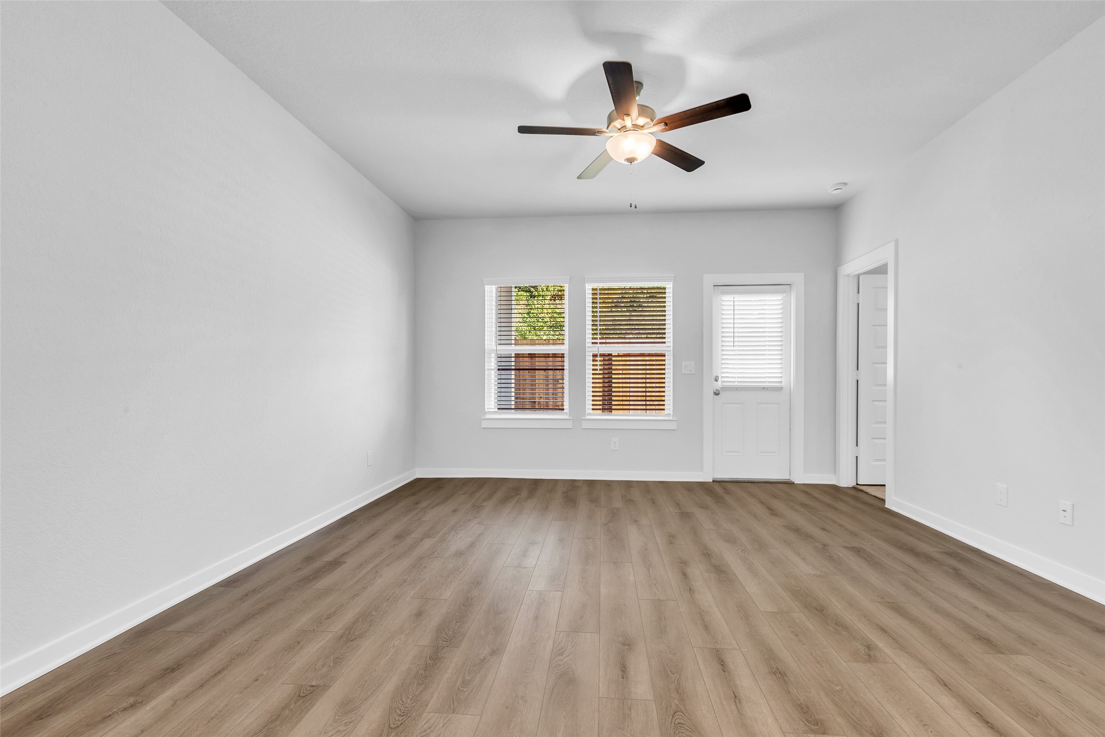 8550 Blueberry Ash Street Magnolia, TX 77354 - Photo 18 of 40 wooden floor in an empty room with a window