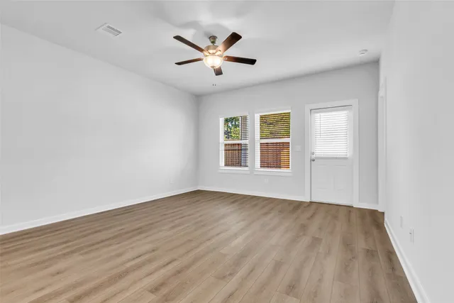 wooden floor in an empty room with a window