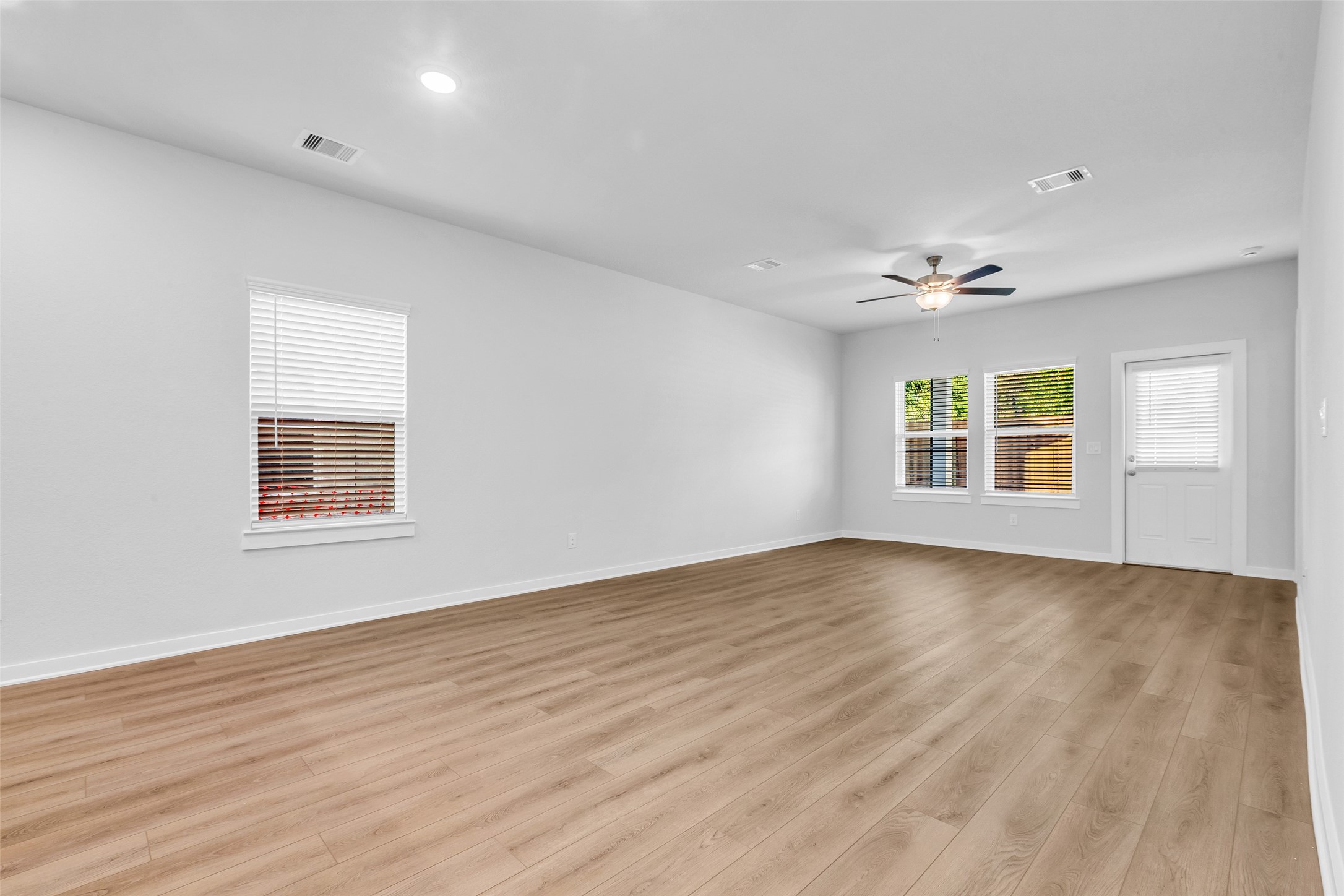 8550 Blueberry Ash Street Magnolia, TX 77354 - Photo 21 of 40 wooden floor in an empty room with a window