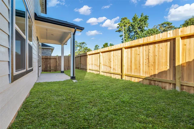 a view of house with backyard and porch