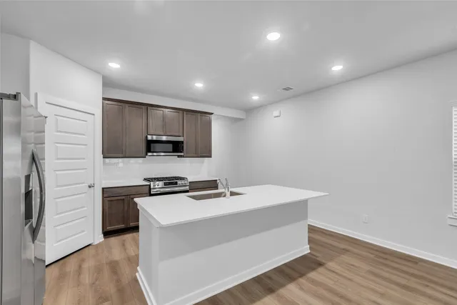 a kitchen with a sink stainless steel appliances and cabinets