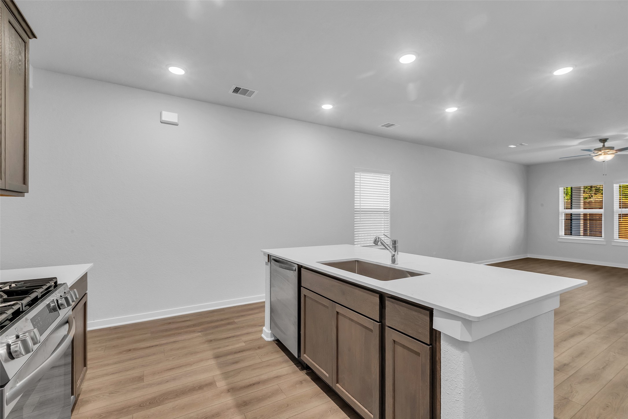 8550 Blueberry Ash Street Magnolia, TX 77354 - Photo 9 of 40 a kitchen with a sink cabinets and wooden floor
