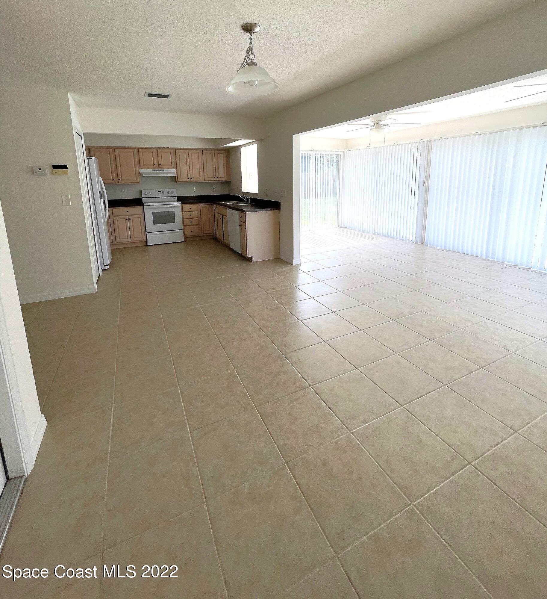 1440 Creel Road Northeast Palm Bay, FL 32905 - Photo 11 of 27 a view of a livingroom with furniture and a window