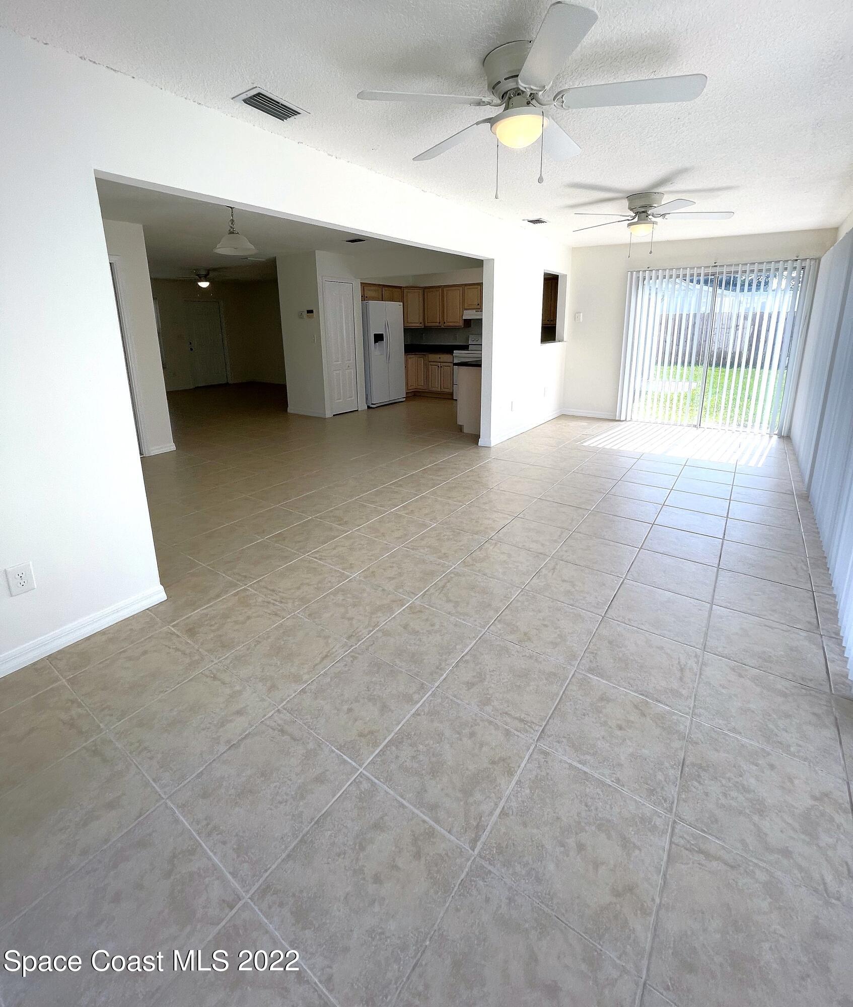 1440 Creel Road Northeast Palm Bay, FL 32905 - Photo 15 of 27 a view of a livingroom with a furniture and a ceiling fan