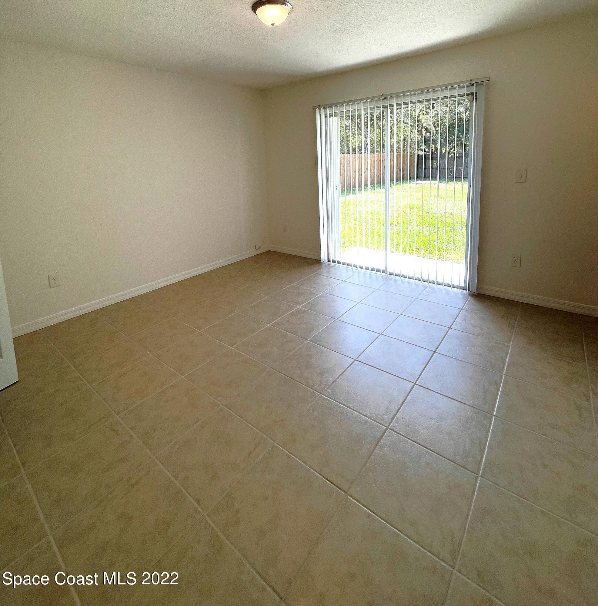 1440 Creel Road Northeast Palm Bay, FL 32905 - Photo 23 of 27 a view of an empty room with a window
