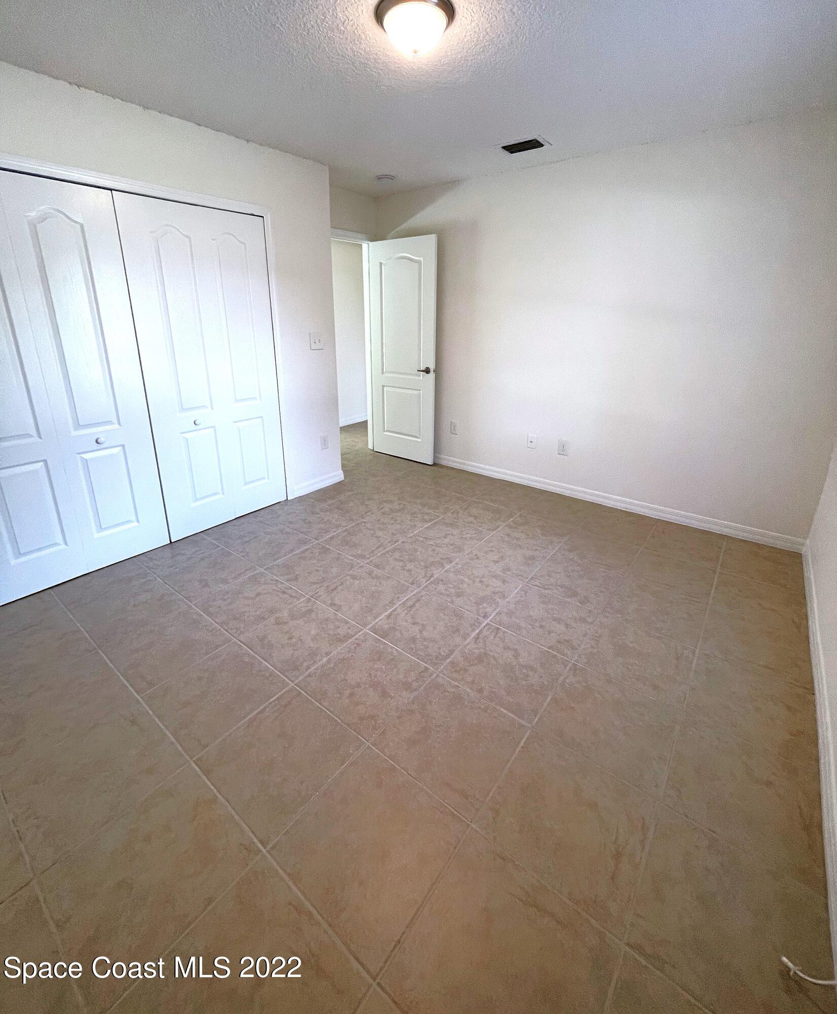1440 Creel Road Northeast Palm Bay, FL 32905 - Photo 25 of 27 a view of an empty room and a window