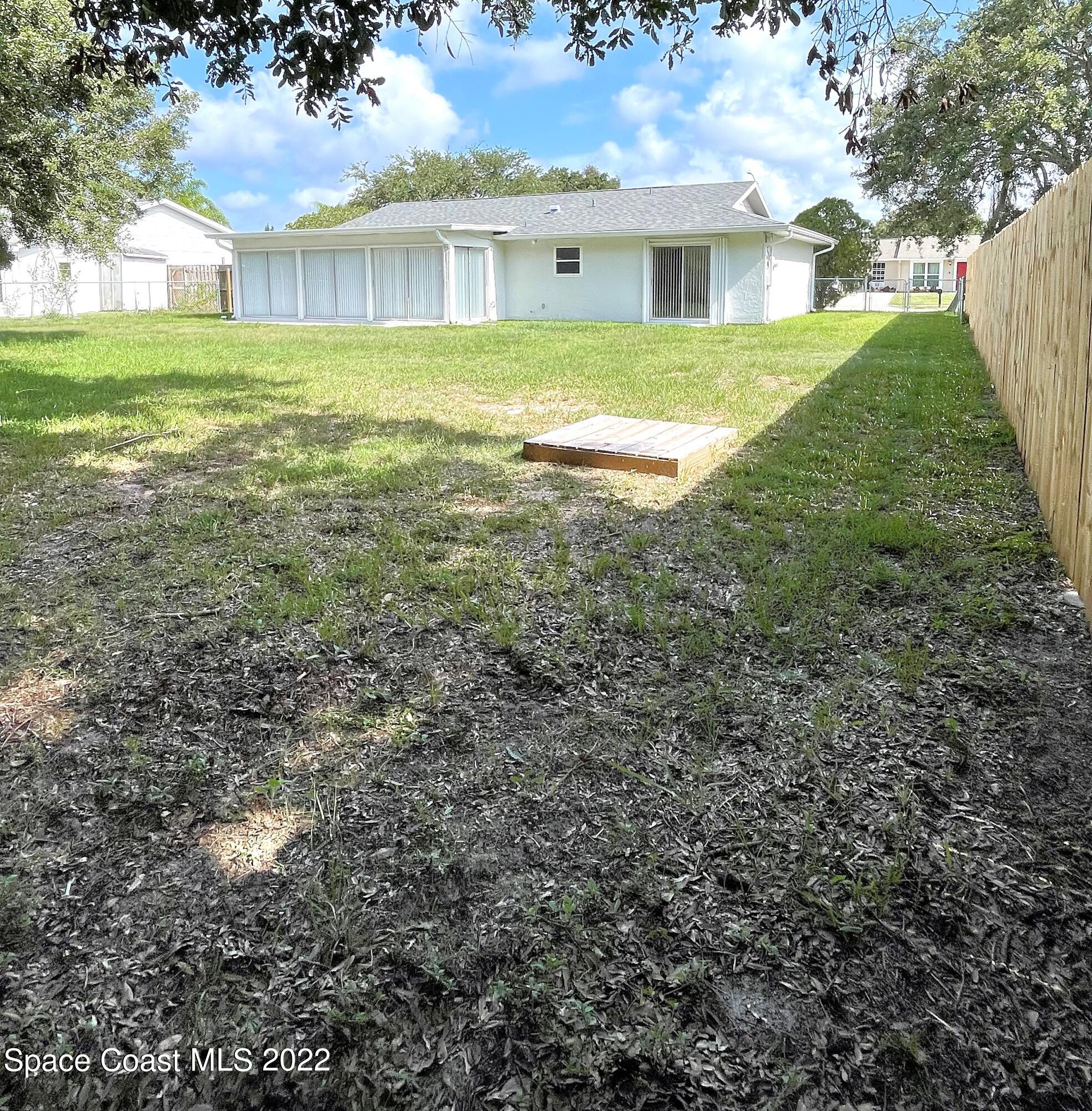 1440 Creel Road Northeast Palm Bay, FL 32905 - Photo 5 of 27 a front view of a house with a yard
