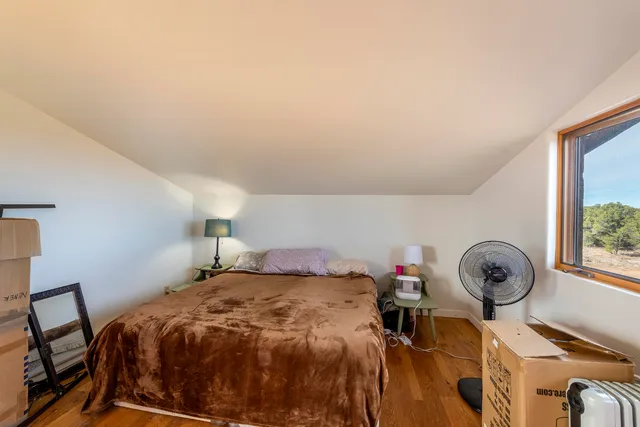 a bed sitting in a room next to a window