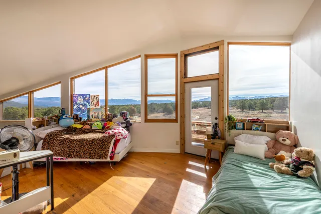 a living room with furniture and large windows