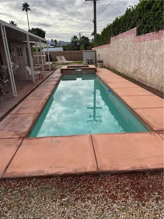 a view of a swimming pool with a yard