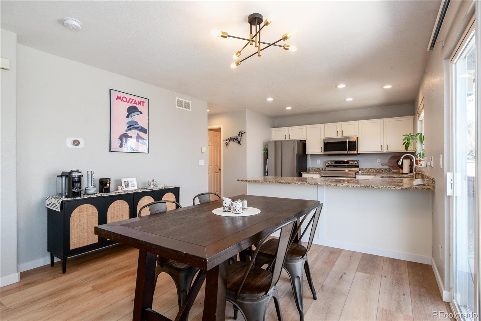 9867 Aftonwood Street Highlands Ranch, CO 80126 - Photo 11 of 41 a view of a dining room with furniture and wooden floor