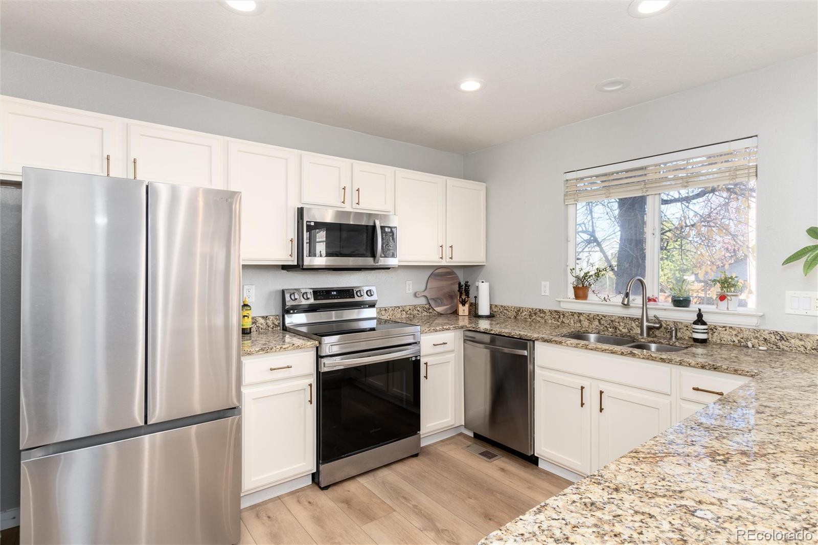 9867 Aftonwood Street Highlands Ranch, CO 80126 - Photo 14 of 41 a kitchen with stainless steel appliances granite countertop a refrigerator sink and stove