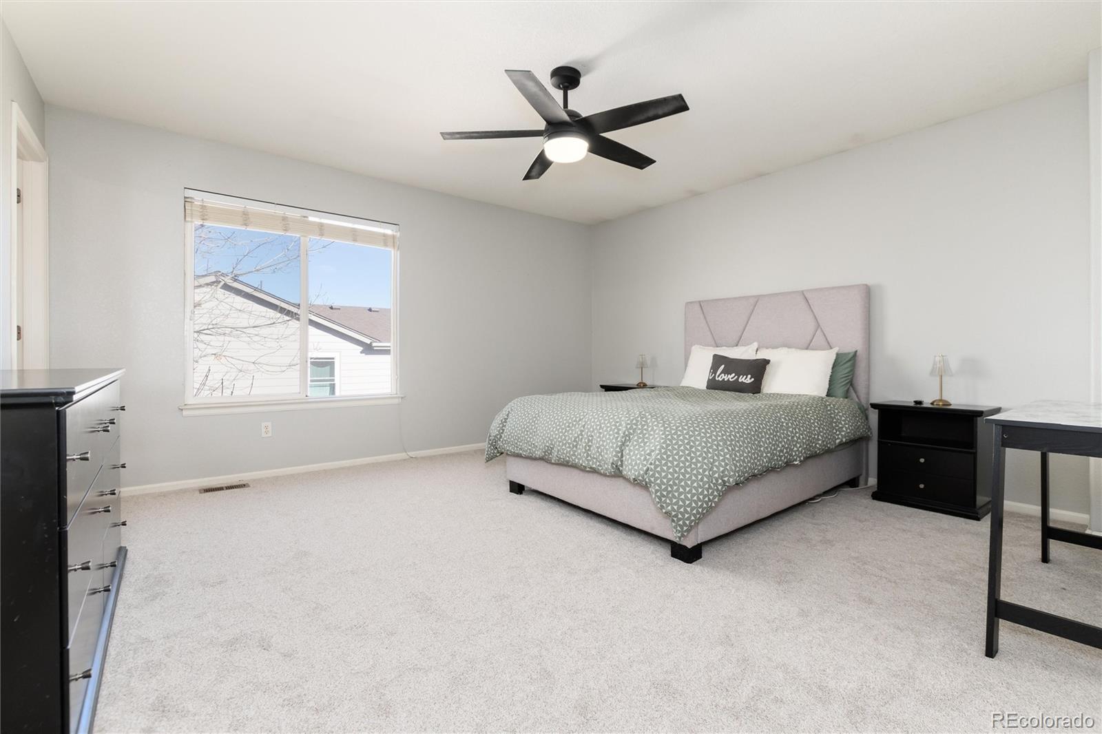9867 Aftonwood Street Highlands Ranch, CO 80126 - Photo 16 of 41 a bedroom with a bed and window