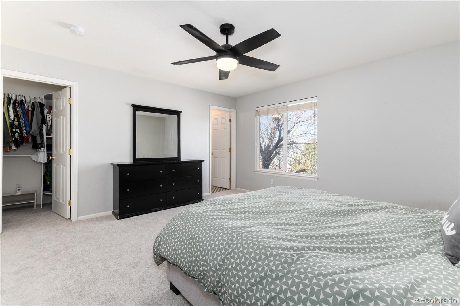 9867 Aftonwood Street Highlands Ranch, CO 80126 - Photo 18 of 41 a bedroom with a bed and a dresser