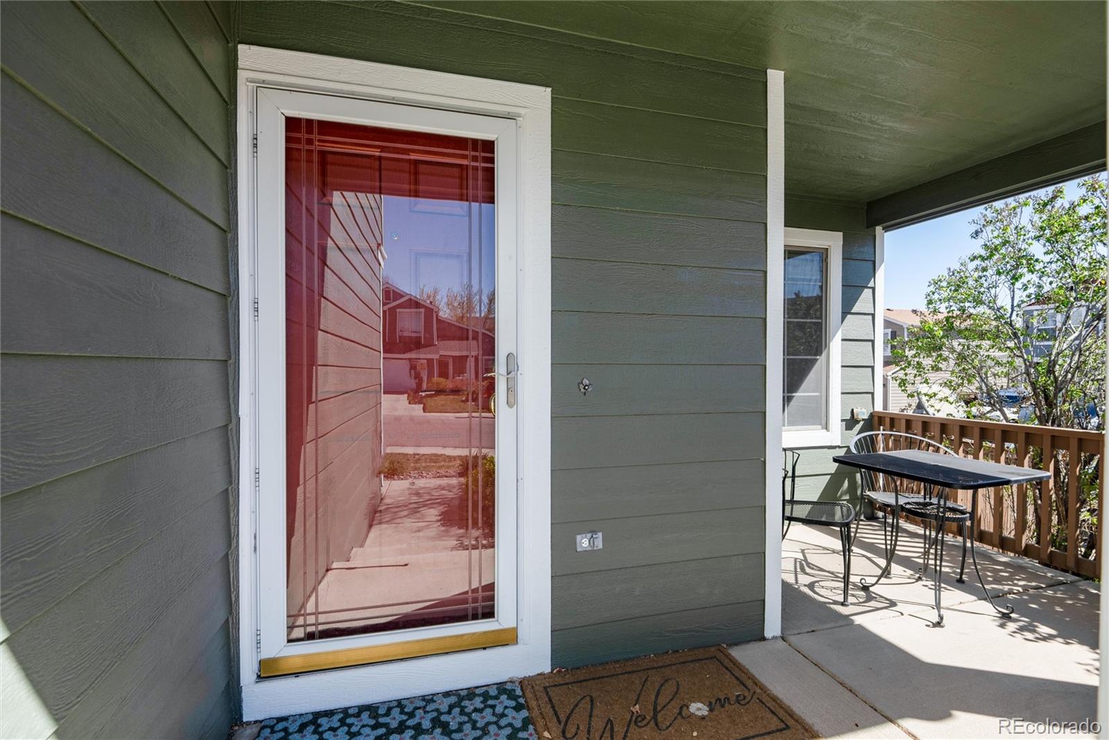 9867 Aftonwood Street Highlands Ranch, CO 80126 - Photo 3 of 41 a view of a door and chair in the balcony