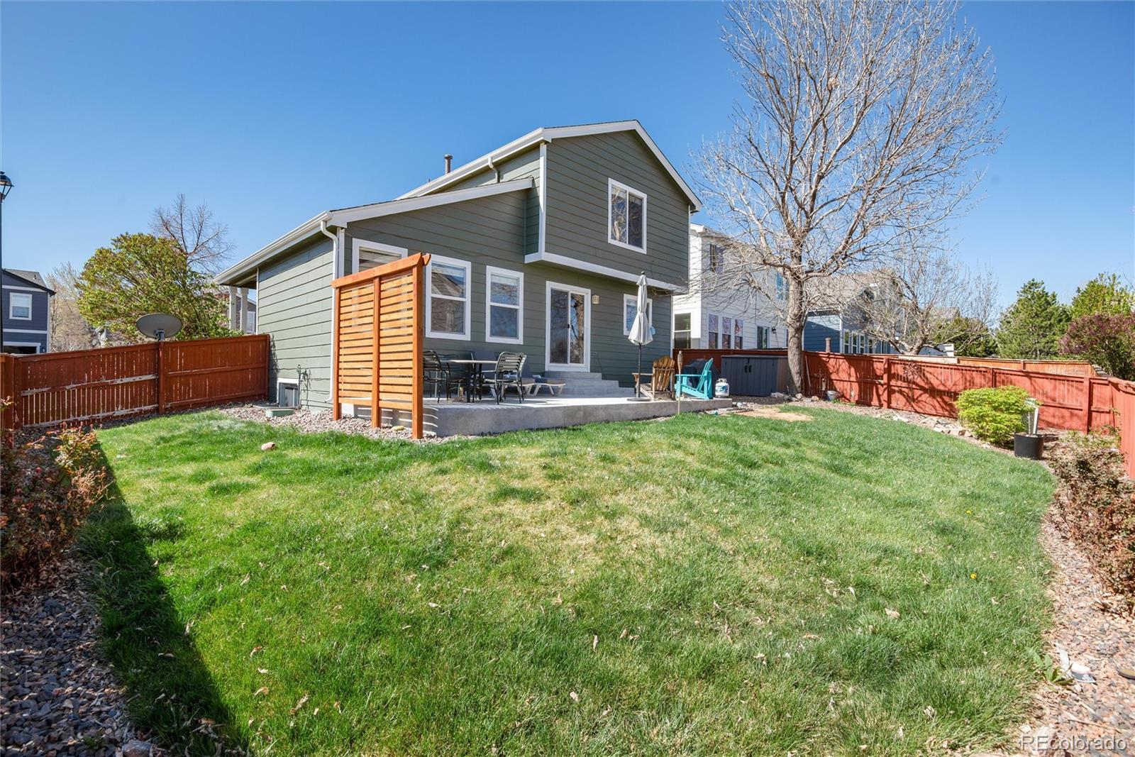 9867 Aftonwood Street Highlands Ranch, CO 80126 - Photo 31 of 41 a front view of a house with a yard table and chairs