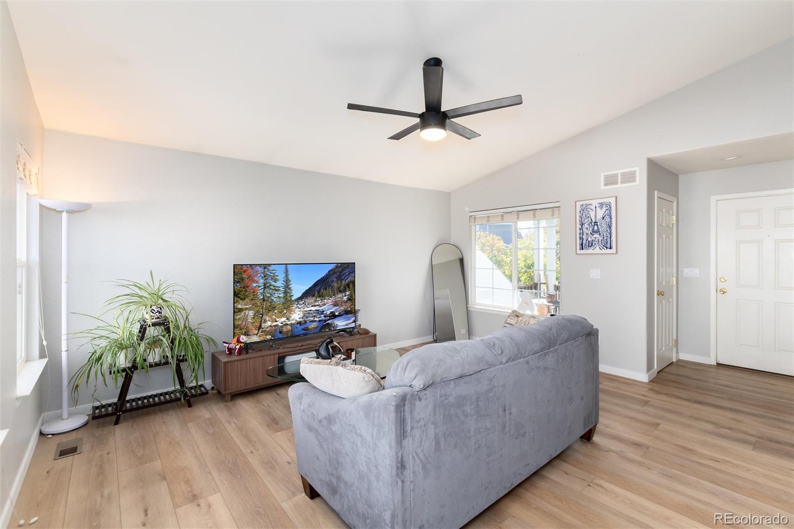 9867 Aftonwood Street Highlands Ranch, CO 80126 - Photo 7 of 41 a living room with furniture and a flat screen tv