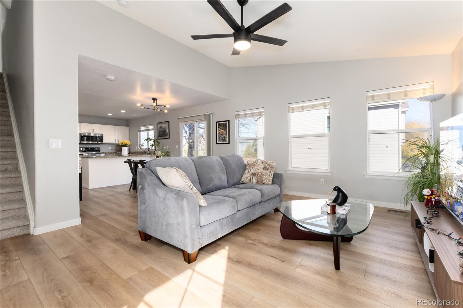 9867 Aftonwood Street Highlands Ranch, CO 80126 - Photo 9 of 41 a living room with furniture and a wooden floor