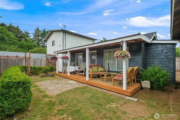 a view of a house with backyard porch and sitting area