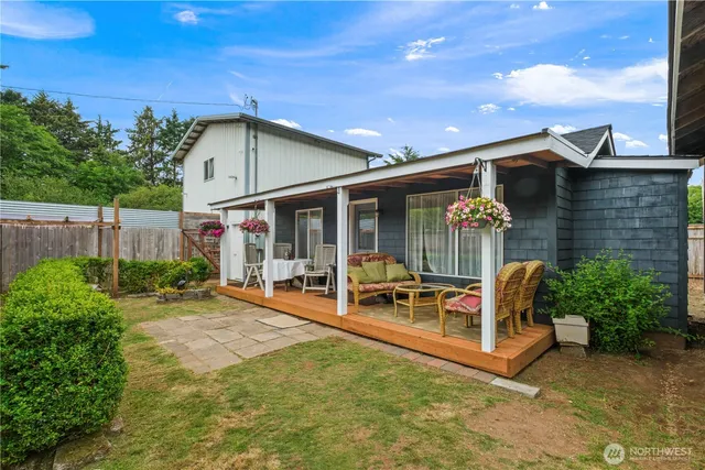 a view of a house with backyard porch and sitting area