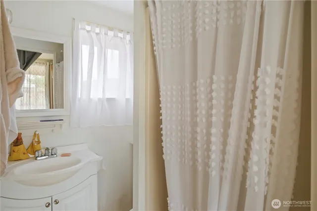 a bathroom with a sink a mirror and a window
