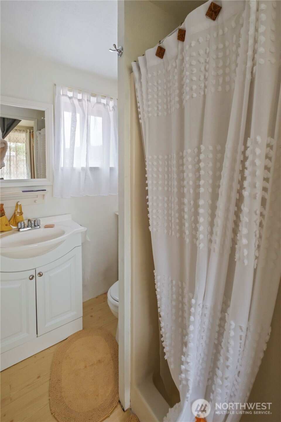 4 Memory Lane Copalis Beach, WA 98535 - Photo 17 of 29 a bathroom with sink a mirror a toilet and vanity