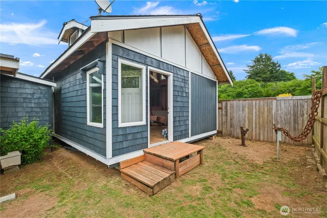 a backyard of a house with table and chairs
