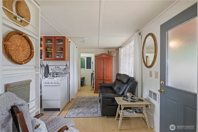 a living room with furniture a rug a fireplace and a window