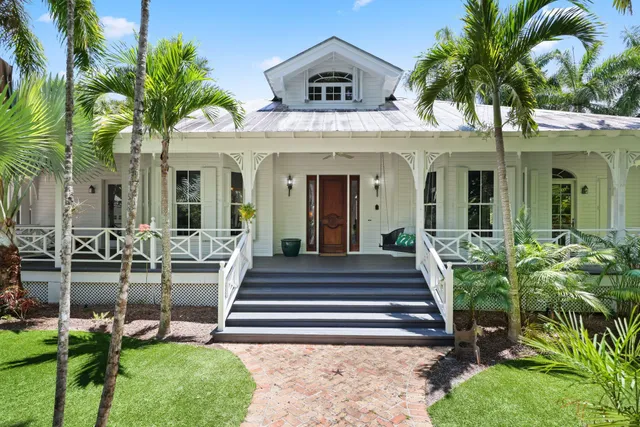 a view of a house with fountain and potted plants