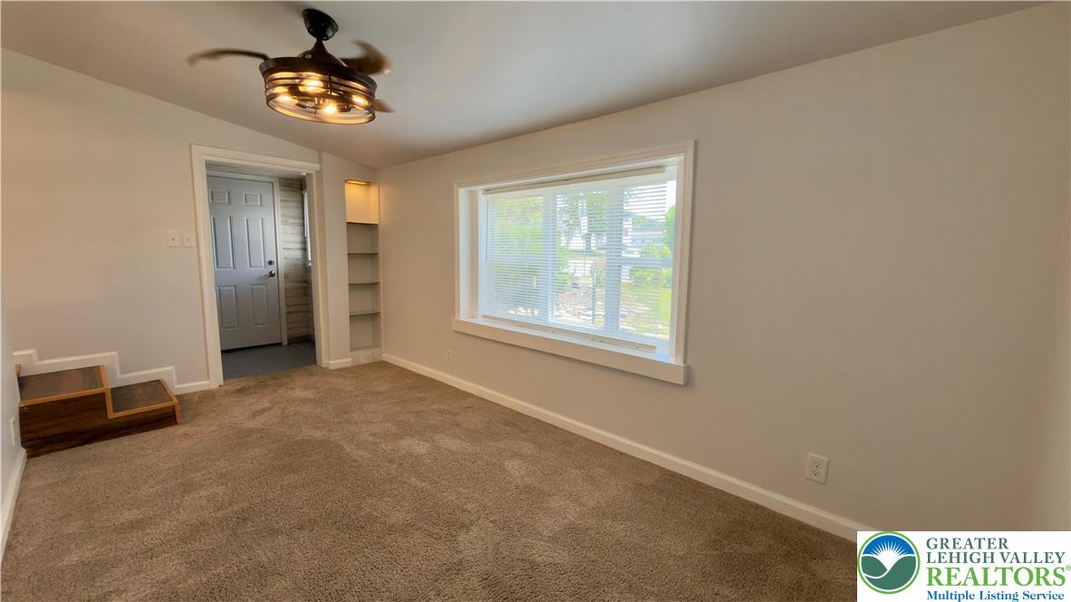 246 Poplar Street Bath, PA 18014 - Photo 11 of 34 A well-lit room showcasing plush carpeting and a convenient ceiling fan.