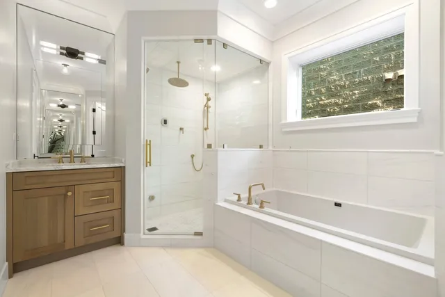 a bathroom with a bathtub shower and sink