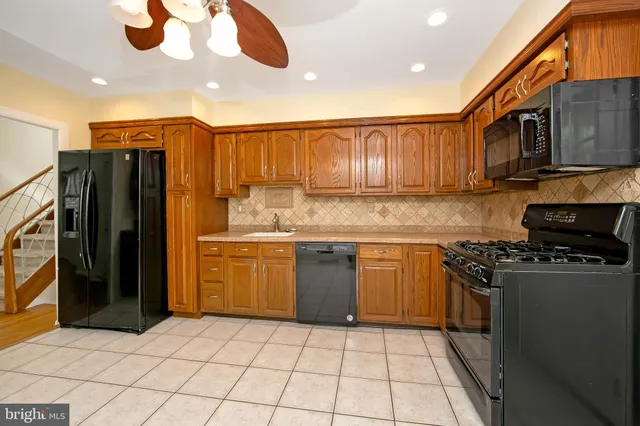 an empty room with closet and a chandelier fan