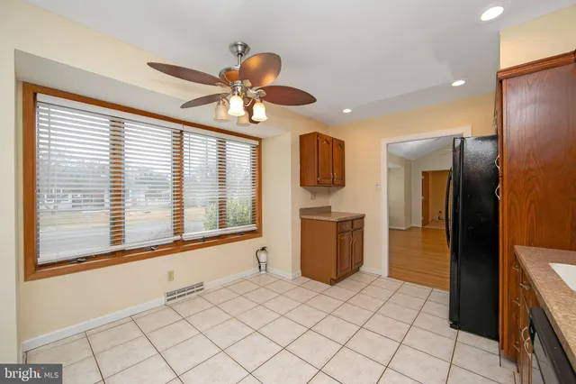 an empty room with a ceiling fan and a window