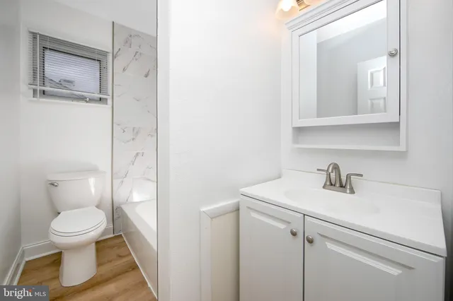 a bathroom with a sink a mirror and a shower